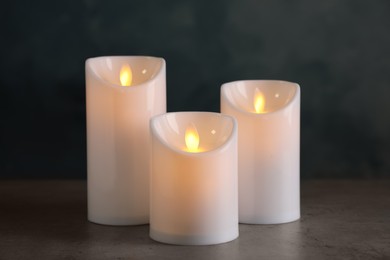Beautiful decorative LED candles on grey table