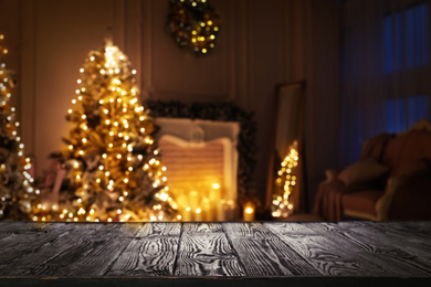 Empty wooden surface and blurred view of room decorated for Christmas