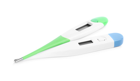 Photo of Modern digital thermometers on white background. Measuring temperature
