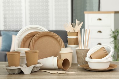 Set of eco disposable tableware on wooden table indoors