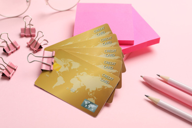 Credit cards and stationery on pink background