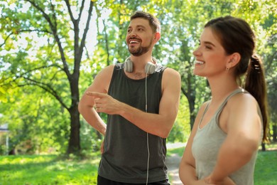 Photo of Man and woman talking before morning exercise in park
