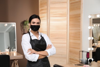 Photo of Portrait of stylist with protective mask in salon, space for text. Beauty services during Coronavirus quarantine