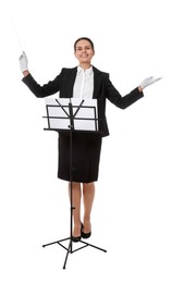 Happy young conductor with baton and note stand on white background