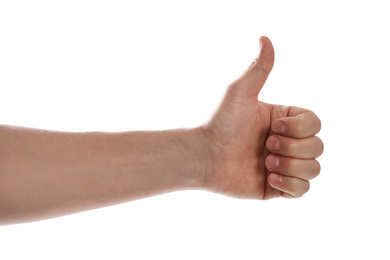 Man showing thumb up gesture against white background, closeup of hand