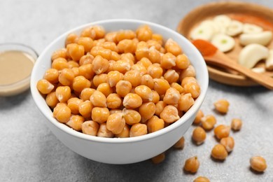 Photo of Delicious chickpeas on light grey table, closeup. Hummus ingredient