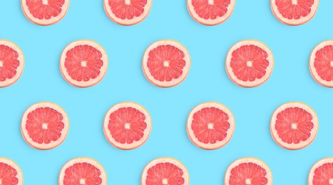 Slices of grapefruits on light blue background, flat lay. Banner design