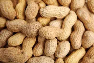 Photo of Heap of raw peanuts as background, top view