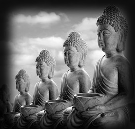 Row of stone Buddha sculptures outdoors. World religion