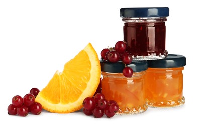Jars with different jams and fresh ingredients on white background