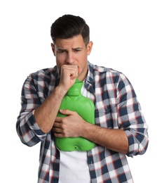 Photo of Ill man with hot water bottle coughing on white background