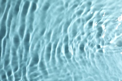 Closeup view of water with rippled surface on turquoise background