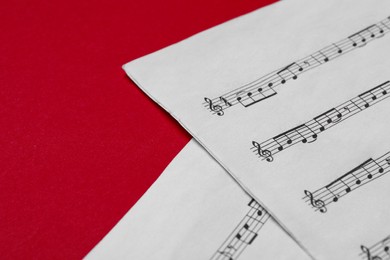 Photo of Note sheets on red background, closeup. Space for text