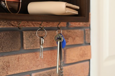 Hanger for keys with accessories on brick wall
