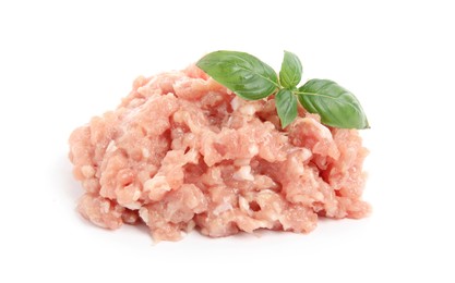 Pile of raw chicken minced meat  with basil on white background
