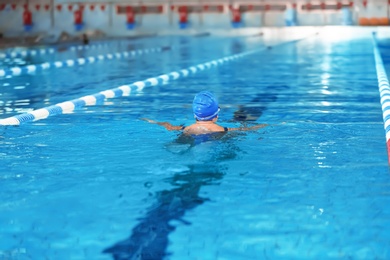 Young athletic woman swimming in pool