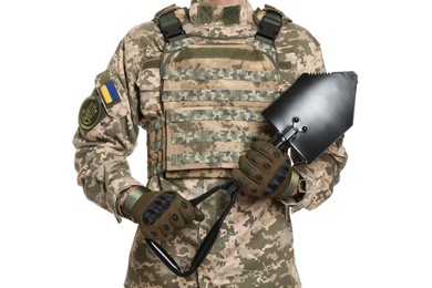Photo of Soldier in Ukrainian military uniform with folding sapper shovel on white background, closeup