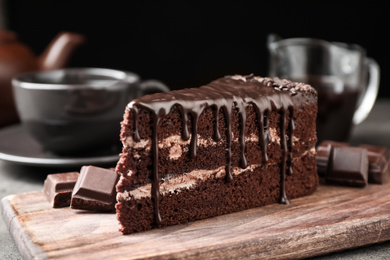 Delicious chocolate cake on grey table, closeup