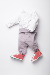 Photo of Child's clothes and booties on white background, flat lay