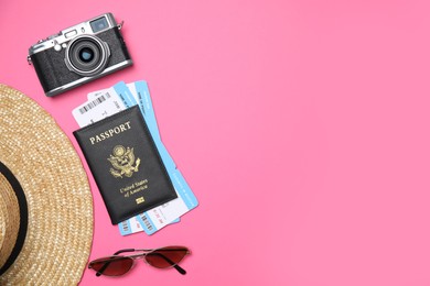 Flat lay composition with passport, tickets and travel items on pink background. Space for text