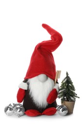 Funny Christmas gnome with tree and baubles on white background