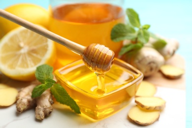Photo of Honey, ginger, mint and lemon on table. Natural cold remedies