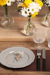 Elegant festive setting with floral decor on wooden table