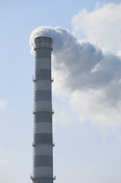 Polluting air with smoke from industrial chimney outdoors. CO2 emissions