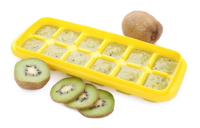 Kiwi puree in ice cube tray and fresh kiwi fruits isolated on white. Ready for freezing
