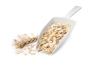 Photo of Raw oatmeal, scoop and spikelet on white background