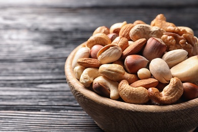 Bowl with organic mixed nuts on table, closeup