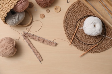 Photo of Flat lay composition with threads and crafting accessories on wooden table. Engaging hobby