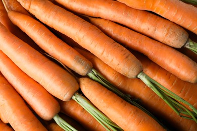 Photo of Many tasty fresh carrots as background, closeup