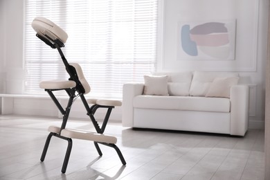 Modern massage chair in office, space for text. Medical equipment