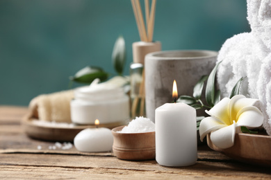 Beautiful spa composition with plumeria flower on wooden table, closeup