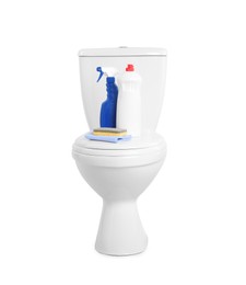 Toilet bowl and cleaning supplies on white background