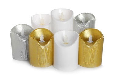 Different decorative flameless LED candles on white background