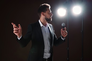 Photo of Motivational speaker with microphone performing on stage