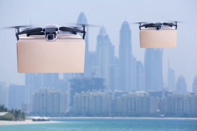 Modern drones with carton boxes flying above sea on sunny day. Delivery service 