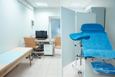 Gynecological clinic interior with chair and doctor's workplace