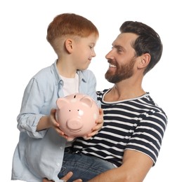 Father and his son with ceramic piggy bank on white background