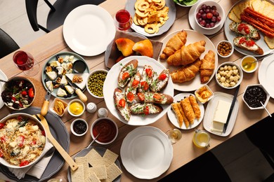 Brunch table setting with different delicious food indoors, top view