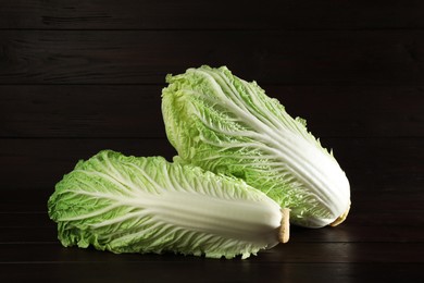 Fresh ripe Chinese cabbages on table against wooden background