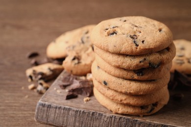 Delicious chocolate chip cookies on wooden table, closeup. Space for text