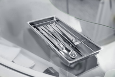Professional dentist tools on glass table in clinic