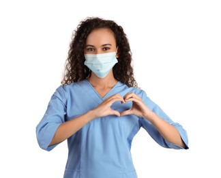 Photo of African-American doctor in protective mask making heart with hands on white background