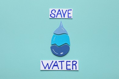 Words Save Water and drop on turquoise background, flat lay