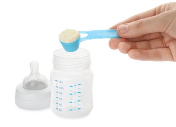 Woman preparing infant formula on white background, closeup. Baby milk