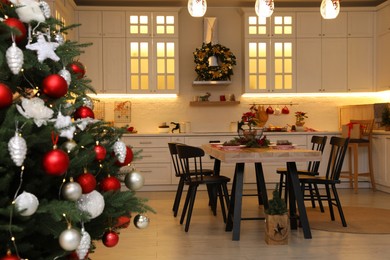 Cozy dining room interior with Christmas tree and beautiful festive decor
