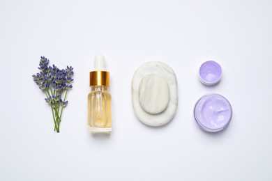 Composition with lavender flowers and natural cosmetic products on white background, top view